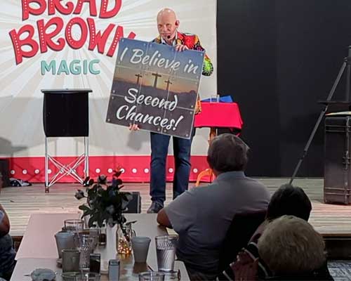 Brad holding a sign that says I Believe in Second Chances.